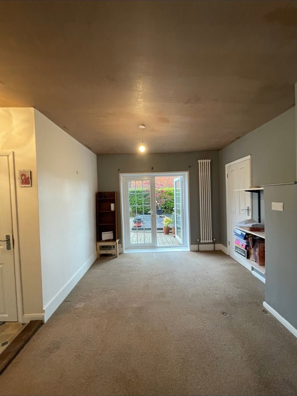Lounge with a newly plastered ceiling running the length of the room