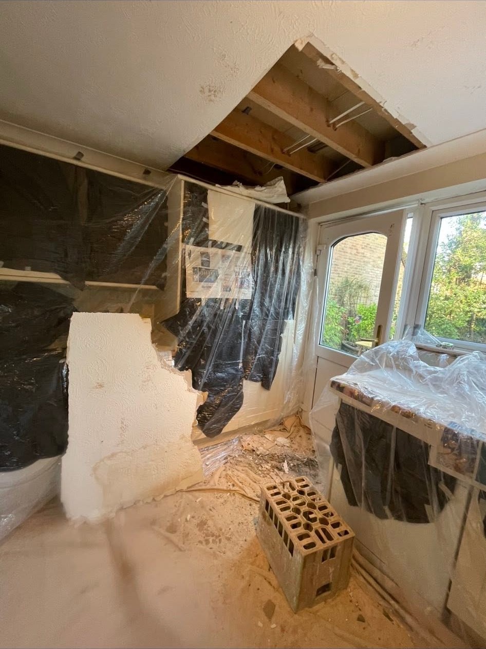 Ceiling and wall stripped back to the joists before replastering